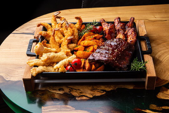 Shrimp platter in batter, fish and chips, rustic potatoes, ribs and wings in BBQ sauce