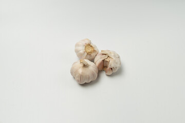 Fragrant garlic lies directly on a white background