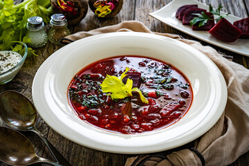 Borsch - beetroots soup on wooden table
