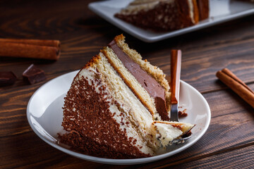 A piece of tiramisu cake on a white plate.