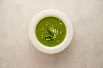 Spinach soup. Green creamy, vegan creamy soup on bright background, top view