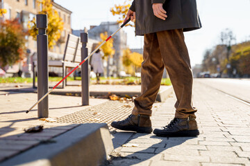 Close-up of a blind man with a walking stick. Detects tactile tiles for self-orientation while...