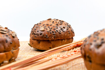 Buns with seeds with bread ears on a white background.