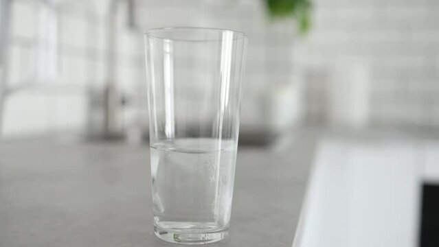 Fizzy pill in glass of water