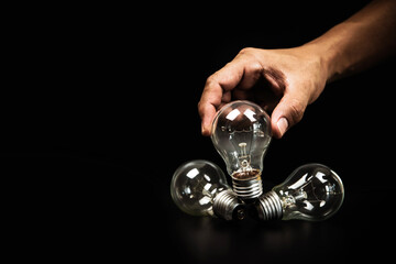 Close up hand choose light bulb or lamp for human resources or leadership and creativity thinking idea motivation or vision and knowledge learning and study or education concept.