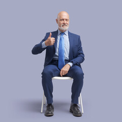 Successful businessman giving a thumbs up