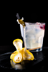 Gin Cocktail with Lemon and honey on black background