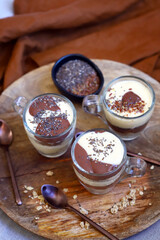 Healthy desserts in mugs. Vanilla and chocolate puddings with chia seeds and linseeds.