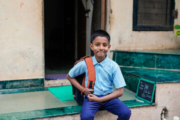 Indian child writing or holding Chalkboard