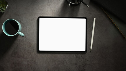 Top view minimal workspace with office supplies and digital tablet on cement surface table