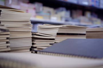 Different notebooks lying on the shelves in the book store