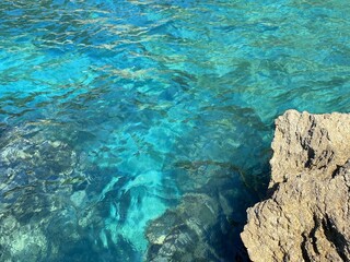 Sea azure blue deep water and rocks.