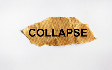 The word COLLAPSE, on a piece of brown paper and a white background