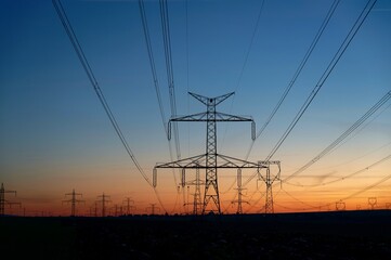 High voltage pylons. Rising energy prices - a concept for industry and energy. Increasing the price of electricity.  The crisis in Europe caused by Russian aggression and the war in Ukraine.
