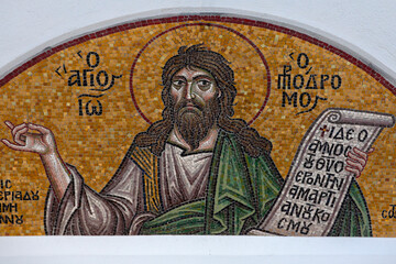 Colourful mosaic hagiography of saint John the Baptist,on the facade above the entrance of the church of the Holy Apostles Peter and Paul in Pefki area in Athens