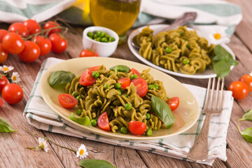 Fusilli pasta with cherry tomatoes and peas.