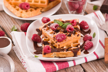 Waffles with raspberries and chocolate cream.