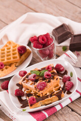 Waffles with raspberries and chocolate cream.