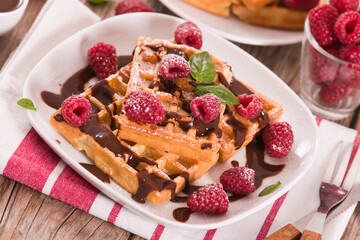 Waffles with raspberries and chocolate cream.