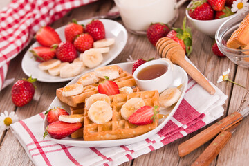 Waffles with strawberries, bananas and honey. - 547702885
