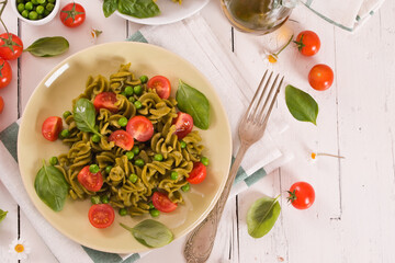 Fusilli pasta with cherry tomatoes and peas.