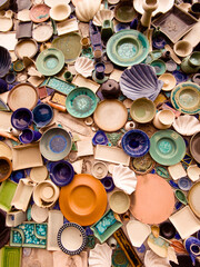 Different colorful ceramic plates on the orange wall