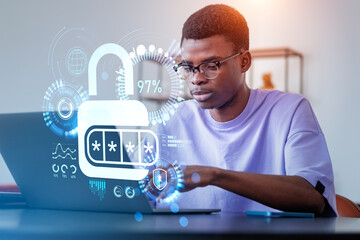 Black businessman working with laptop, padlock hud and data secu