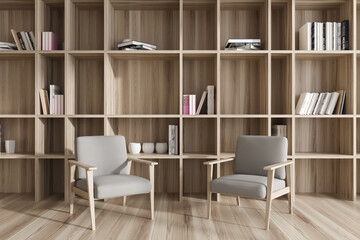 Front view on bright living room interior with two armchairs © ImageFlow