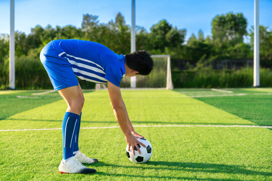 football player set ball football on grass at free kick point before shoot or kick to win a score in international league football match stadium