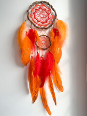 Close-up red dream catcher bohemian wall hanging craft indoors