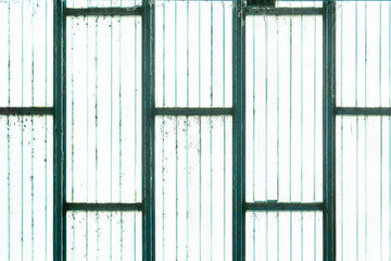 texture of an old plastic window with green frame