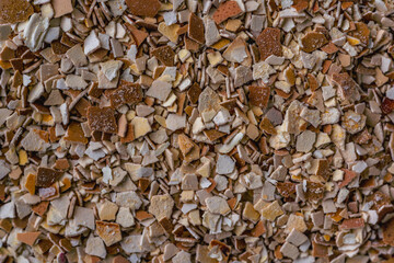 Used crashed chicken eggshell used as a fertiliser for plants, flowers and tomatoes. Change from littering Into storage and processing, home made organic fertilizer. Nature background texture