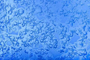 Frost patterns on window glass in winter