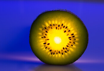 glowing kiwi slice on blue background