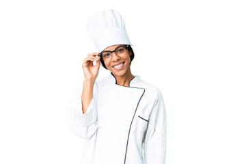 Young African American chef over isolated chroma key background with glasses and happy