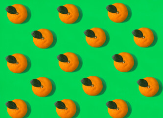 Tangerine on the green background. Flat lay. Pattern. Top view.