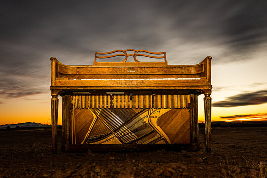 abandoned piano at sunset