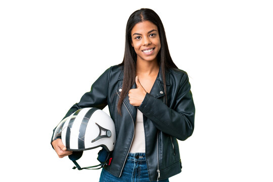 Young African American woman with a motorcycle helmet over isolated chroma key background giving a thumbs up gesture