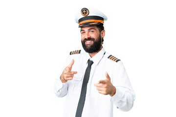 Airplane caucasian pilot man over isolated chroma key background pointing to the front and smiling