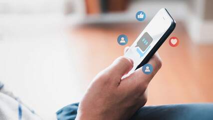 Selective focus at men hand while type on smartphone while chat and communication with friend on...