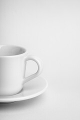 High key image of part of an esspresso cup and saucer with copy space.