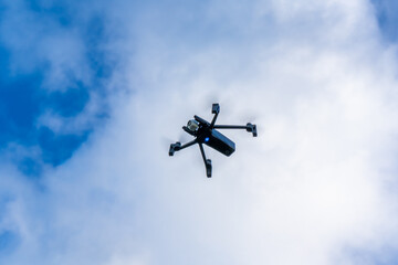 Fototapeta na wymiar Drone flying in from of a clouds sky