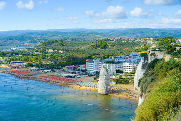 Vieste, Italy. Panoramic view from the top of the Lungomare Enrico Mattei beach with the famous Pizzomunno Monolith rising into the sea. September 5, 2022.