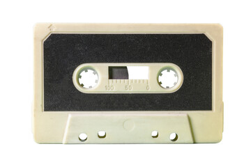 Isolated old vintage cassette tape from the 1980s (obsolete music technology). Sand white plastic body, carbon black paper label.
