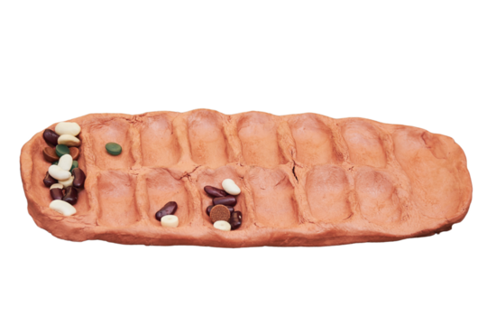 African game of kalah, popular in ancient Rome, isolated on a white background. Reconstruction of board games from the Roman Empire