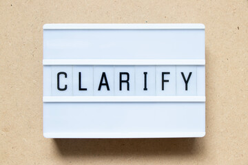 Lightbox with word clarify on wood background