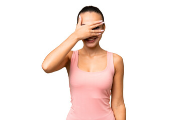 Young Arab woman over isolated background covering eyes by hands and smiling