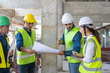 team of civil engineer manager, maintenance supervisor, professional technician foreman together with safety operator inspect and discuss the infrastructure of building construction progress at site