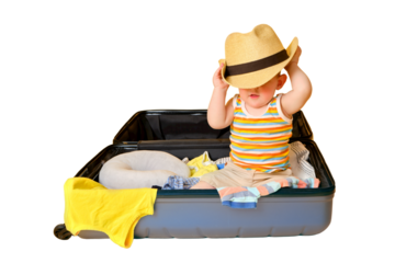 Baby toddler boy sits inside a suitcase with clothes, studio isolated on white background. A child plays in a big bag while packing luggage for a vacation trip. Kid age one year (12 months)