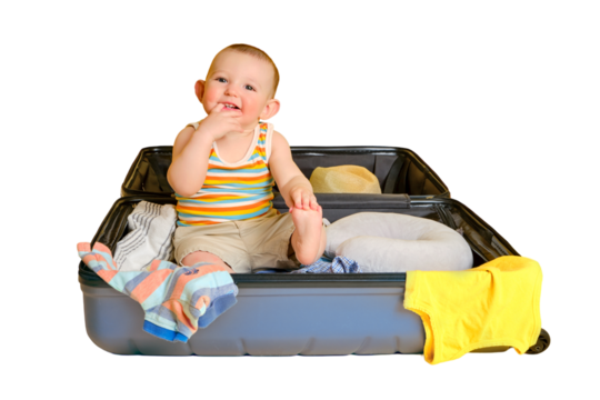 Baby toddler boy sits inside a suitcase with clothes, studio isolated on white background. A child plays in a big bag while packing luggage for a vacation trip. Kid age one year (12 months)